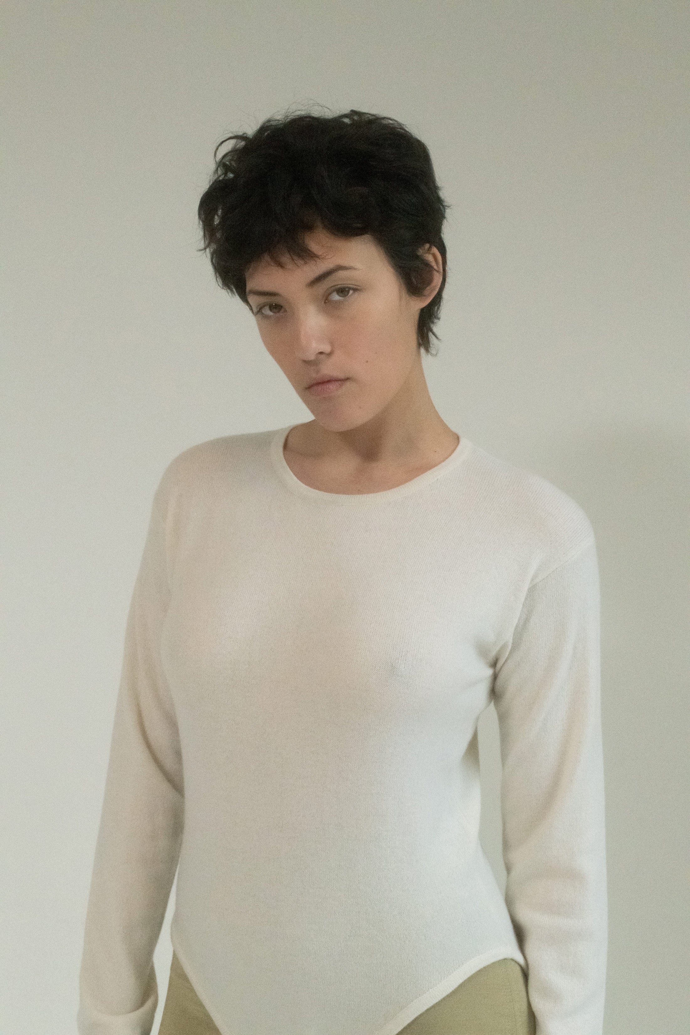 Crafted from the finest cashmere, this long-sleeve bodysuit wraps around you like a lover’s embrace, soft and inviting.