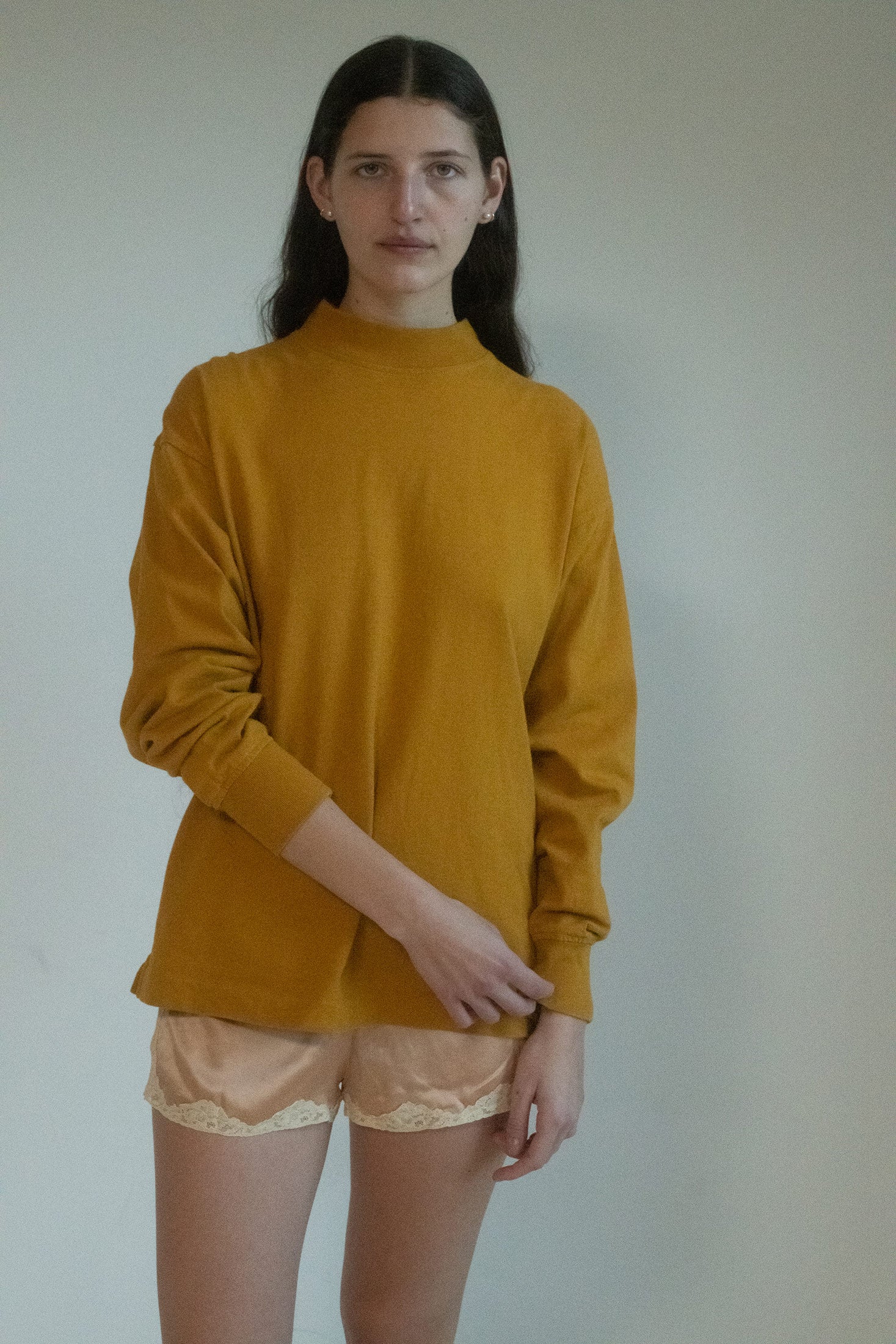 Introducing the mock neck top by Lemaire – a garment where simplicity becomes an art form, and color breathes life into the quiet corners of your day. 
