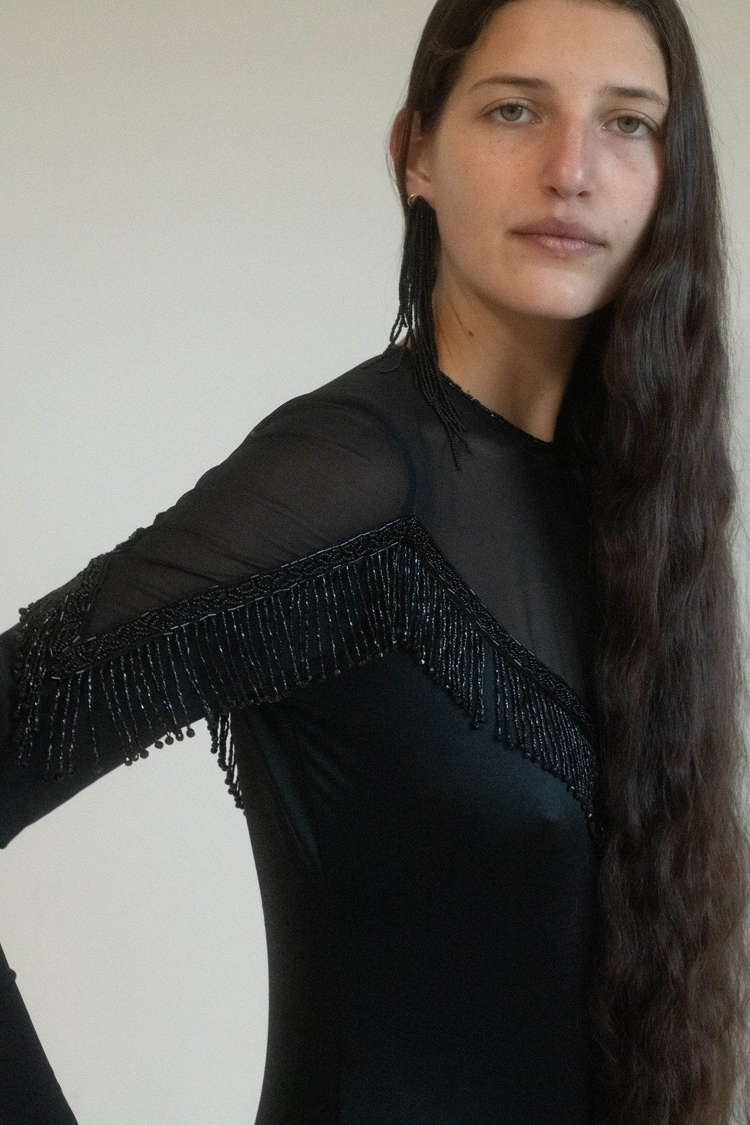 The sheer cutout neckline adds an air of mystery—a glimpse of skin, a suggestion, but never too much. 