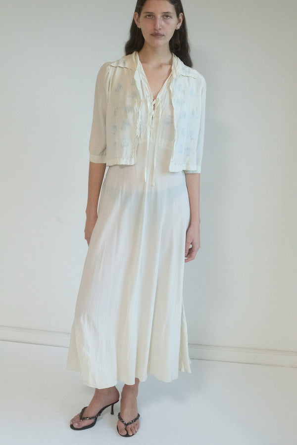 A vintage slip dress, soft and delicate, whispering stories of a time before.