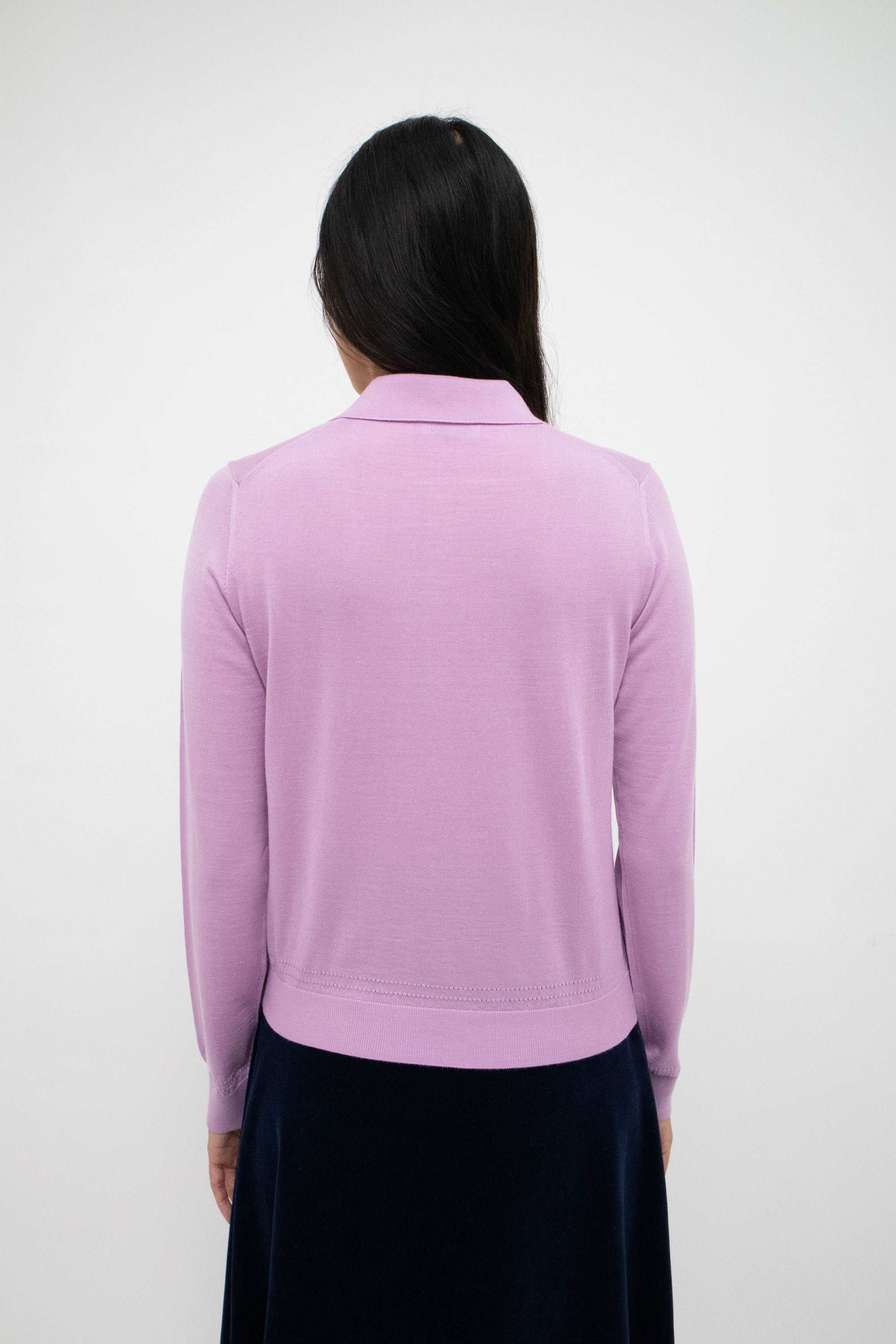 It's spread collar beckons with an irresistible promise of mystery, while the intricate pointelle motif adorning its silhouette hints at concealed desires.